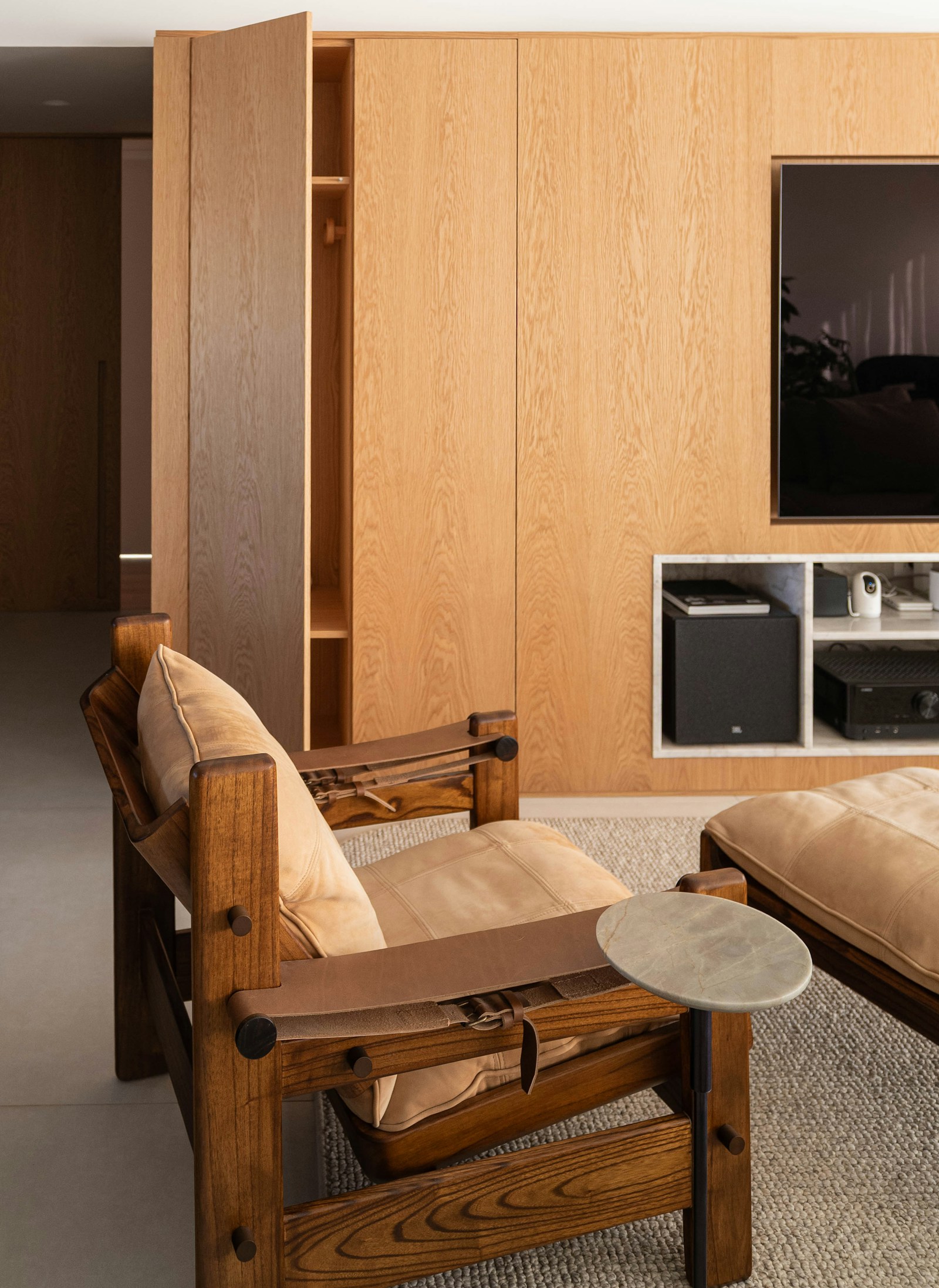 Custom oak wood TV cabinetry with concealed storage and media equipment panel