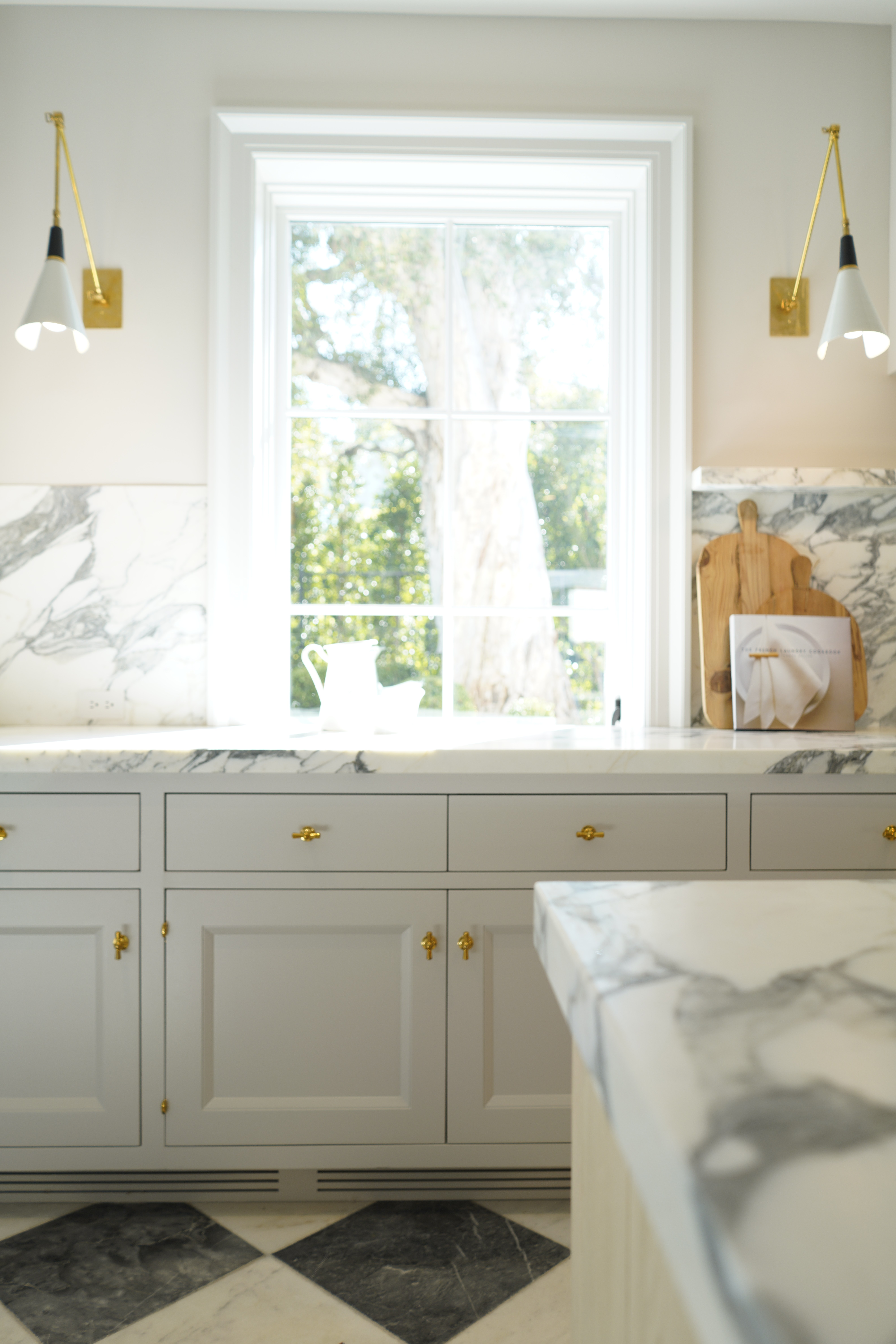 Custom white kitchen cabinet column brass hardware detail