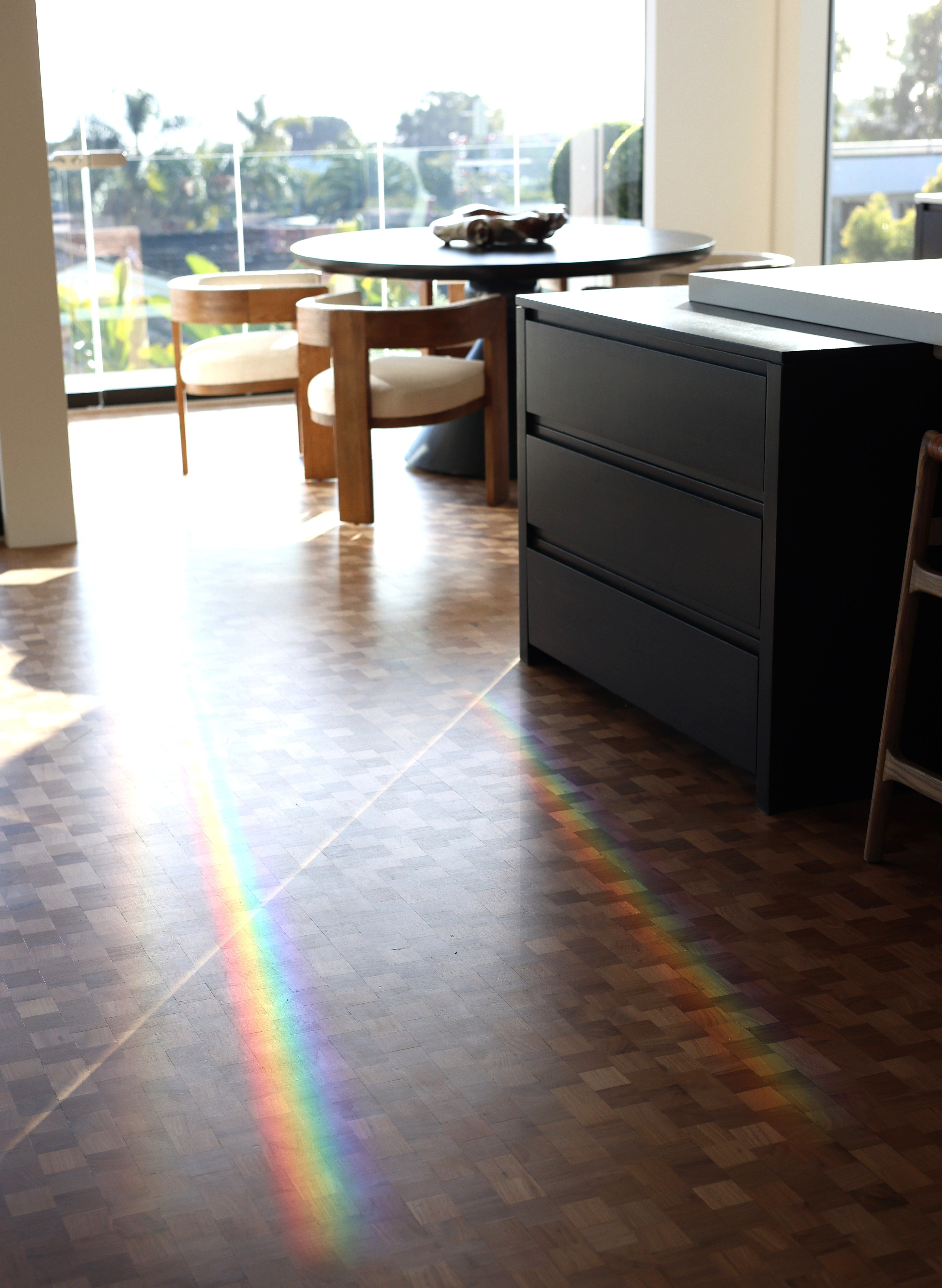 Modern dark kitchen island rainbow light herringbone floor