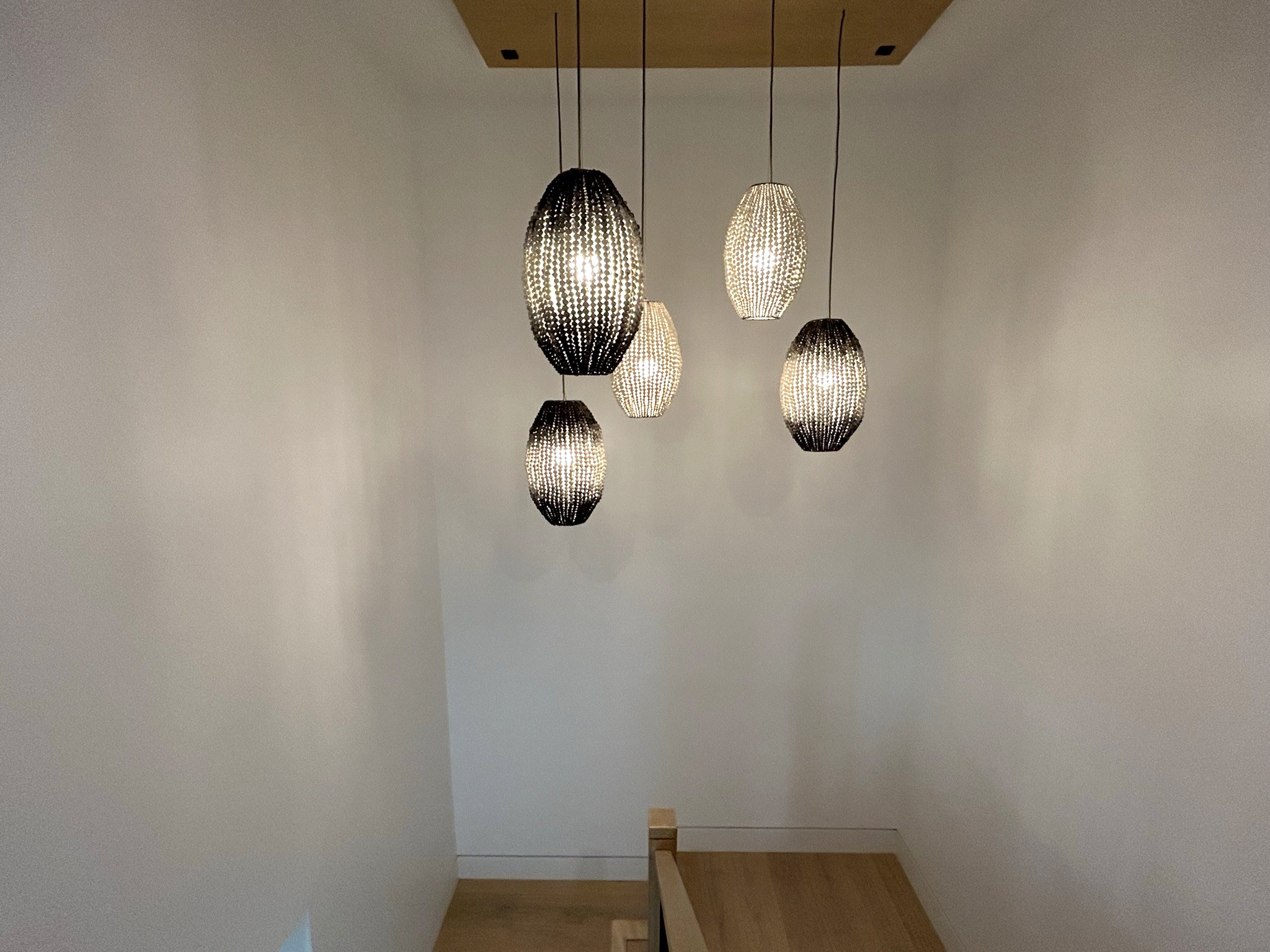 Modern home staircase pendant lights stairwell view