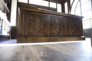 Ornate dark carved wood credenza front panel detail