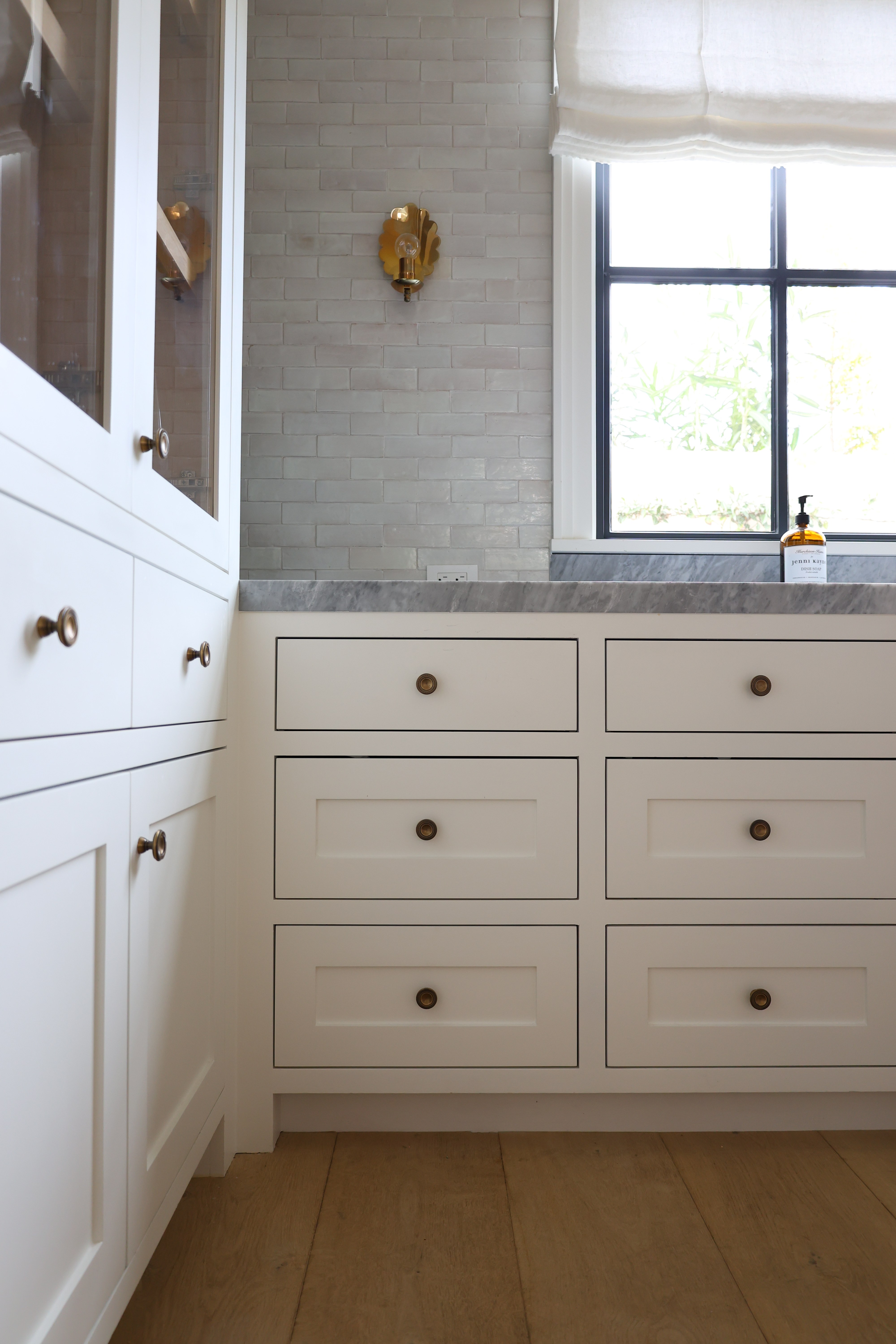 Custom white bathroom cabinet brass knobs zellige tile