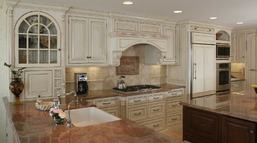 Ornamental cabinet detail showing carved panel, applied moulding, and premium decorative hardware