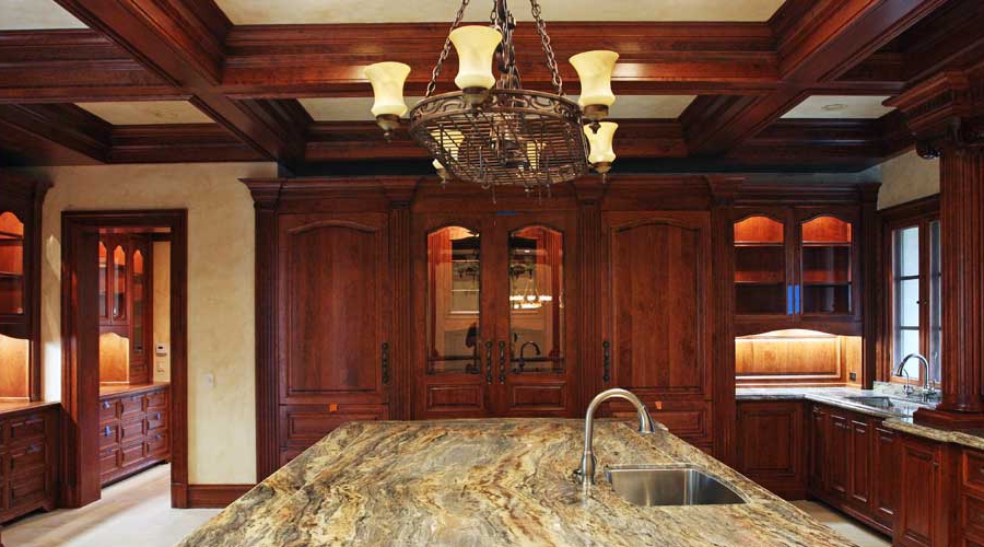 Baroque-style custom cabinetry with sculptural carved detail and layered moulding profiles