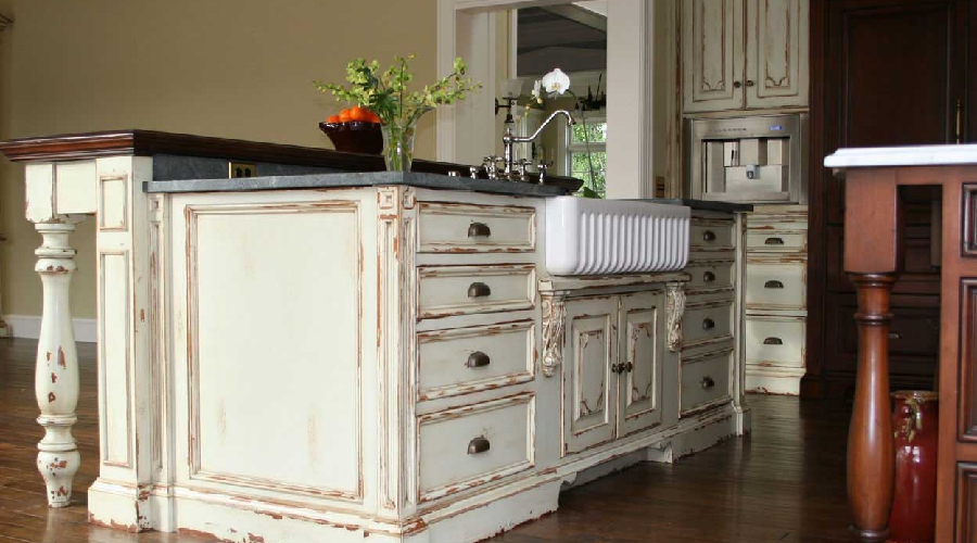 Rustic custom kitchen cabinetry with natural wood grain, warm finish, and handcrafted details