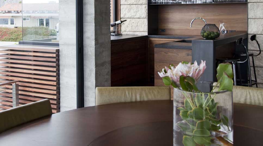 Rustic custom kitchen cabinetry with natural alder, farmhouse sink, and iron hardware, Newport Beach