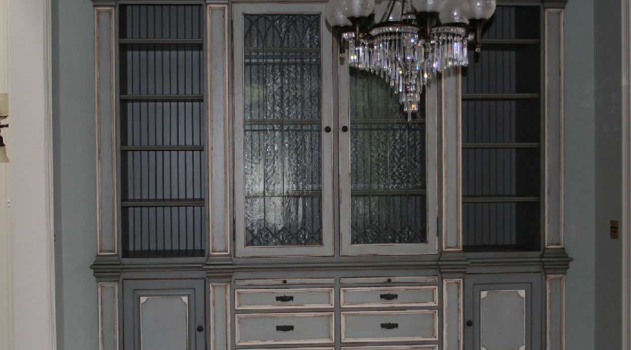 Shabby chic custom cabinetry installation with soft whites and antique brass hardware, Orange County