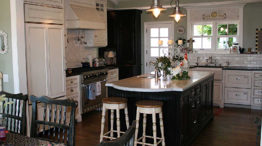 Antique-style custom cabinetry with classical detailing, aged finish, and traditional hardware